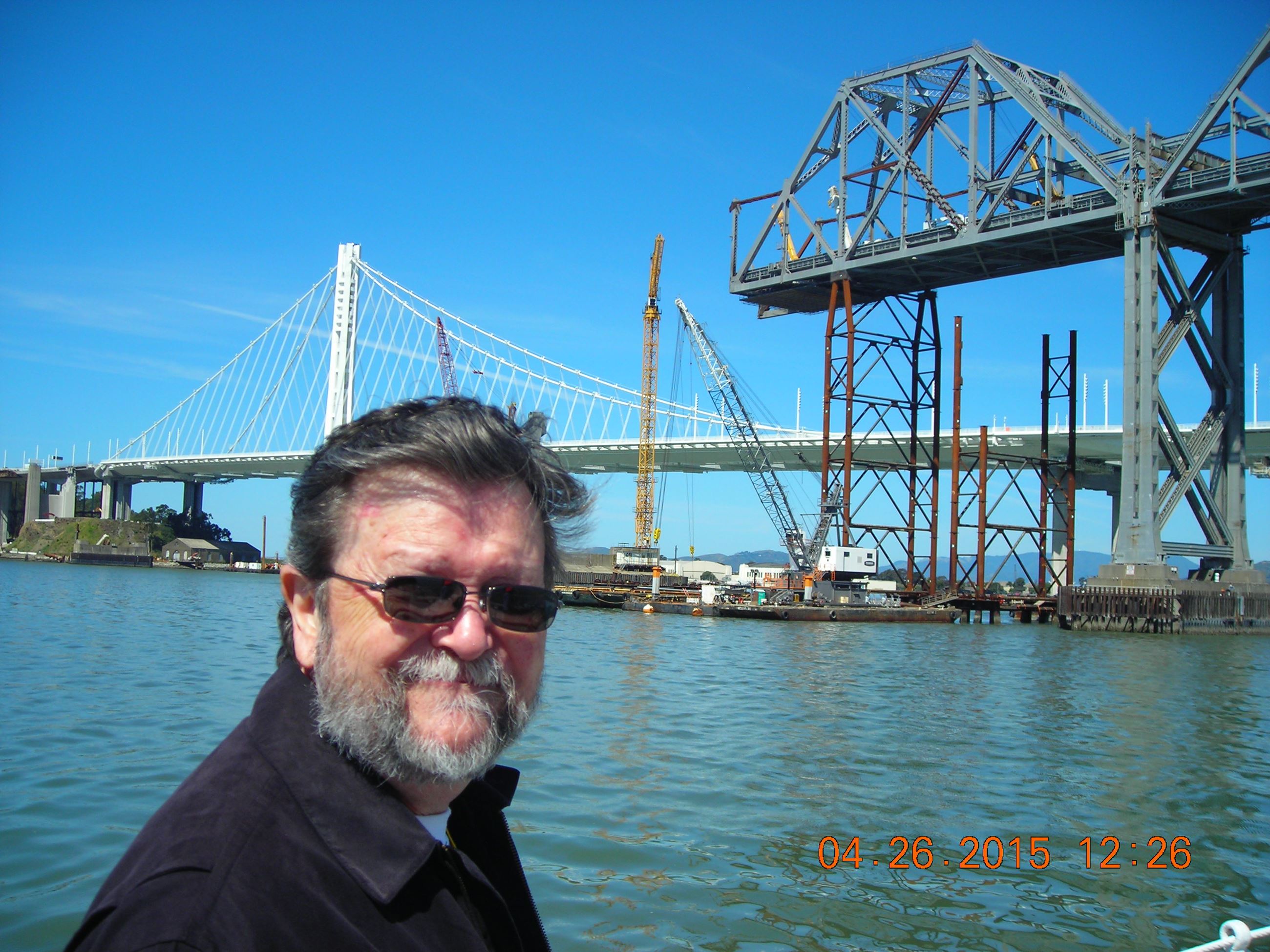 Ron enjoys the view of the new bridge and the old bridge as it is being disassembled.