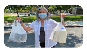 Senior Volunteer holding up grocery bags