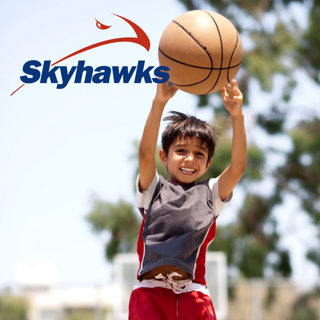 Boy jumping with basketball over his head